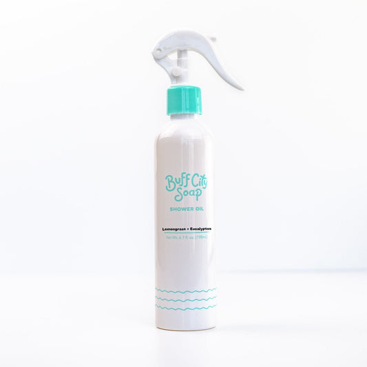Lemongrass Eucalyptus Shower Oil bottle with teal writing against white background
