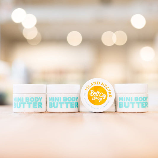 Four Island Nectar Mini Body Butter containers lined up on counter