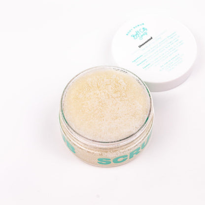 Open jar of Unscented Body Scrub with lid placed next to it